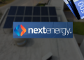 Nextenergy Logo Centered on a Blurred Rooftop with Solar Panels; a Stack of Blue Banknotes is Visible in the Top-right Corner. - Hola Mty